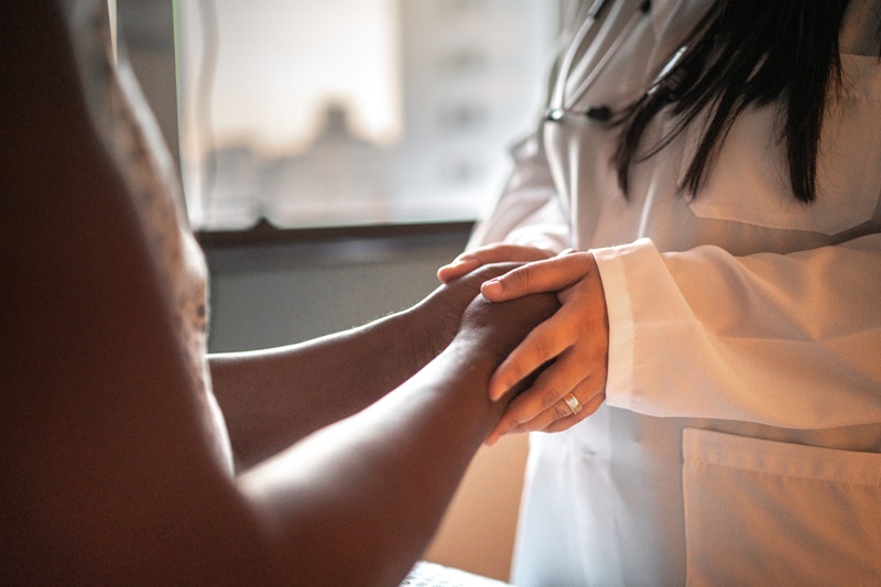 Doctor comforting patient